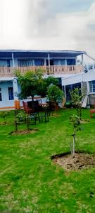 a building with a table and chairs in a yard at MATENI's B&B in Naivasha