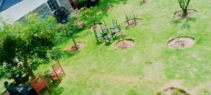 an aerial view of a yard with chairs and trees at MATENI's B&B in Naivasha +3 photos