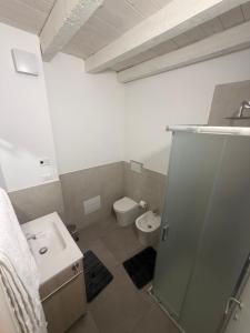 a bathroom with a sink and a toilet at Vittoria Tre Piazze Apartments in Brescia +26 photos