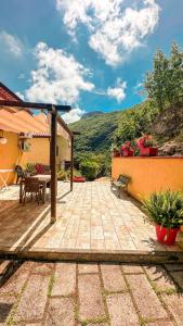 a patio of a house with a table and a bench at Casa Santicelli Maratea ' I CARPINI ' in Maratea