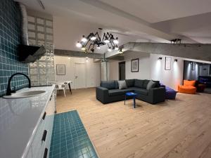 a living room with a couch and a table at Kazbegi Apartments in Kazbegi