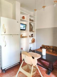 a kitchen with a white refrigerator and a table at Darna in Marrakesh