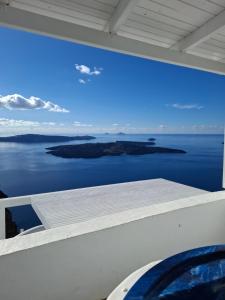 a view of the ocean from the balcony of a house at SMART Emboreio stay in Emporio