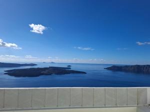 an island in the water with a blue sky at SMART Emboreio stay in Emporio