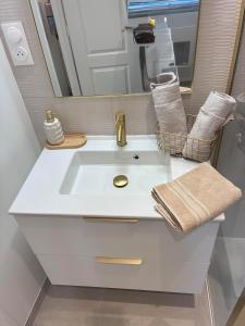 a bathroom with a white sink and a mirror at Le Jaurès in Brie-Comte-Robert +18 photos