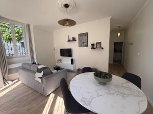 a living room with a table and a couch at Le Jaurès in Brie-Comte-Robert