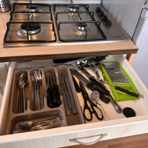 a drawer filled with utensils in a kitchen at Blueportel Horizon L40 in Le Portel