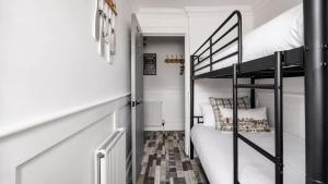 a small room with a bunk bed and a staircase at Melbourne Place Apartment in Port Bannatyne