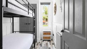 a bedroom with a bunk bed next to a door at Melbourne Place Apartment in Port Bannatyne