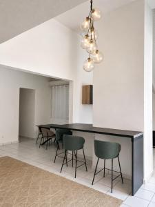 a dining room with a black table and chairs at Le Palm Loft in Pointe-à-Pitre
