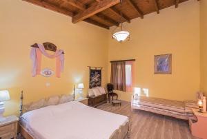 a bedroom with a bed and a bench in a room at Villa Feakia in Agios Gordios