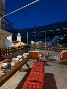 a patio with a table and chairs on a roof at La mina's house in Symi