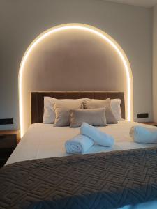 a large bed with two pillows on top of it at Eden's Garden luxury Studio in Kalamitsi