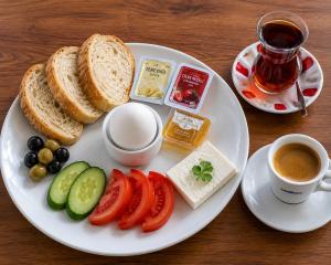 a plate of food with bread and vegetables and a cup of coffee at G-25219Kaya Royal Hotel By Wsd Hotels Group in Istanbul