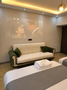 a living room with a couch and a movie poster at Deal Otel in Uzungöl