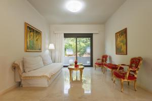 a living room with a couch and a table and chairs at Villa Katrin in Ialysos +32 photos