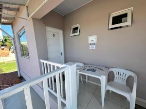 a room with a table and chairs on a balcony at Pousada da Igreja in Pântano Grande
