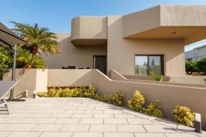 a house in the desert with a patio at Villa Katrin in Ialysos