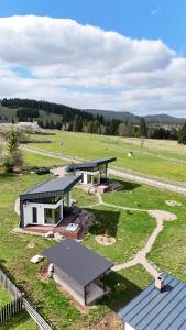an aerial view of a house in a field at La Cuiburi in Sărişor