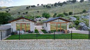 a couple of buildings in front of a hill at Ballkoni i Goricës in Goricë