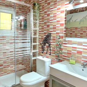 a bathroom with a zebra head on the wall at Casa D' alao in Santiago de la Ribera +21 photos