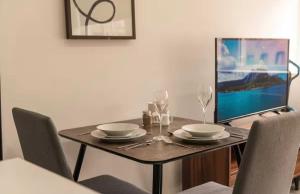 a dining room table with a laptop computer on it at Comfortable 1 Bed Apartment Town Centre in Preston