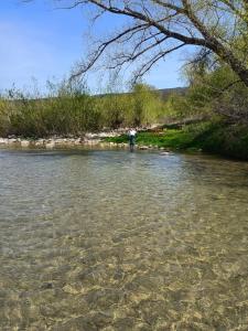 a person standing in the water in a river at Mulino di Pari - Where Time Slows in Pari