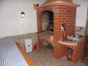 a kitchen with a brick oven with a sink at Apartments Mrva in Ugljan +120 photos