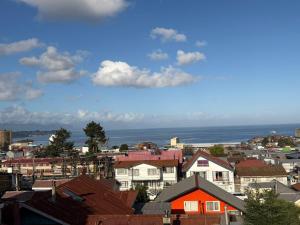 a view of a city with houses and the ocean at Altos de Miramar in Puerto Montt
