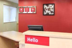 an office with a hello sign on a red wall at TownePlace Suites Lubbock in Lubbock