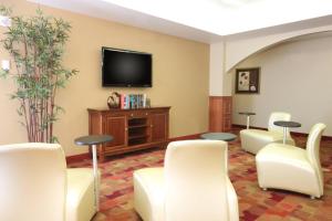 a waiting room with white chairs and a flat screen tv at TownePlace Suites Lubbock in Lubbock +37 photos