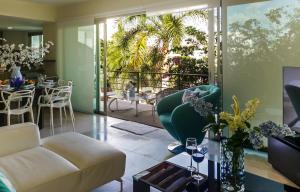 a living room with a couch and a table at Luxurious & Central Condo In Playa Steps From The Beach in Playa del Carmen