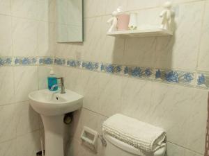 a bathroom with a sink and a toilet and a mirror at Hospedaje de Lidia in Lima +74 photos