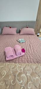 a bed with pink blankets and a tray on it at Camp Kalinovac in Zatonje