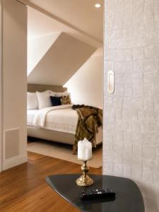 a room with a bed and a table with a mirror at The Crown Penthouse Bahnhofstrasse in Zurich