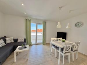 a living room with a couch and a table at Ksenija Apartments in Tučepi