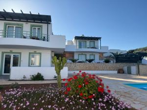 a house with flowers in front of it at Cavo Plako Villas in Palekastron