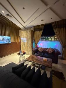 a living room with a couch and a table at Hilton Suites Lahore in Lahore