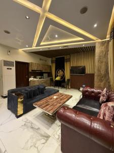 a living room with leather furniture and a table at Hilton Suites Lahore in Lahore