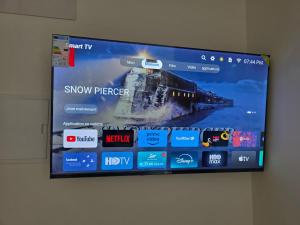 a tv hanging on a wall with a train on it at Le calme d'ajdir in Ajdir