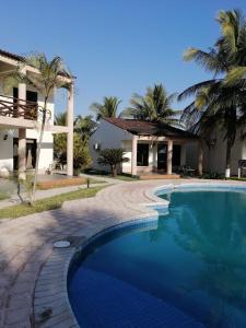 a swimming pool in front of a house at Hotel & Resort Casa Bella in El Hawaii