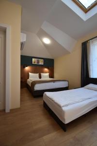 a bedroom with two beds and a window at Simada Center Guesthouse in Varshets +66 photos