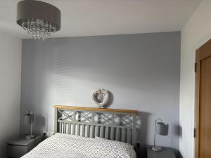 a bedroom with a bed and two lamps and a mirror at Beach House in Donegal