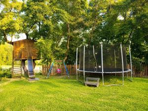 a playground with a trampoline in a yard at Casa Campomonte 2 in Poppi Stazione