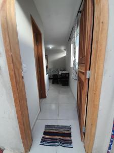 a hallway with a door and a rug on the floor at Kitnet Perequê in Matinhos