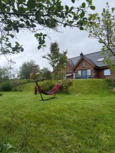 a hammock in a yard in front of a house at Laimhrig Lockley in Torrin