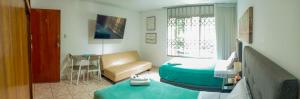 a hotel room with a bed and a couch at Hospedaje de Lidia in Lima