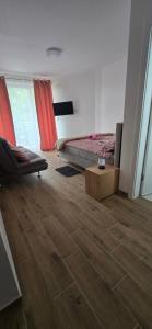 a room with a bed and a wooden floor at Camp Kalinovac in Zatonje