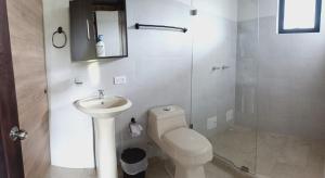 a bathroom with a toilet and a sink and a shower at El Eden in Sáchica +3 photos