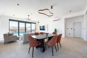 a dining room with a table and chairs at Krimovica Villas in Budva